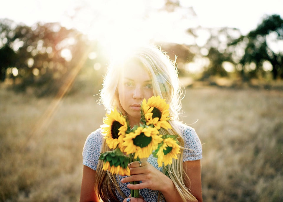 SUN KISSED HAIR GIRL HOLDING SUNFLOWERS