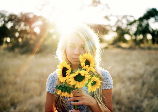 SUN KISSED HAIR GIRL HOLDING SUNFLOWERS